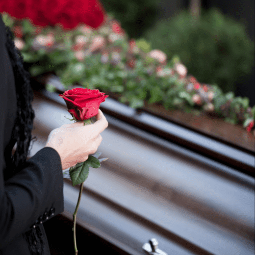 Woman holding flower in funeral.