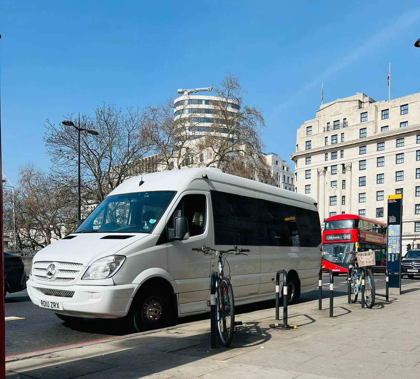 A white bus parked on the side of a street.